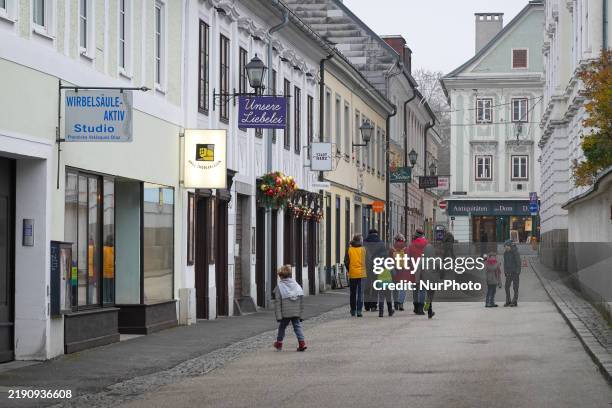 Daily life in Linz, Upper Austria, Austria, on December 26 includes walkers in the old town of Linz.