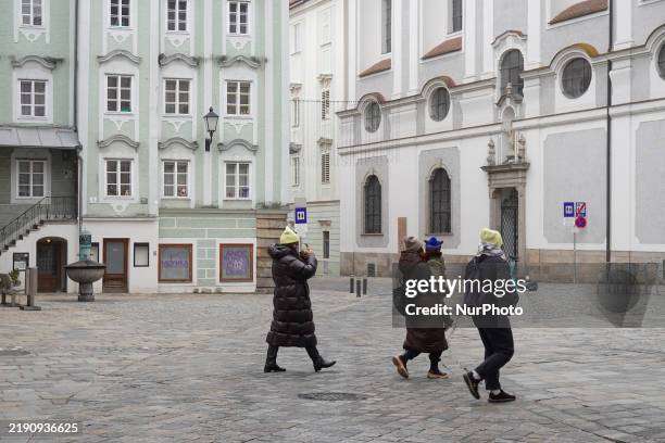 Daily life in Linz, Upper Austria, Austria, on December 26 includes walkers in the old town of Linz.