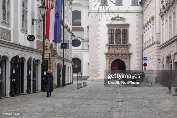 Daily life in Linz, Upper Austria, Austria, on December 26 includes walkers in the old town of Linz.