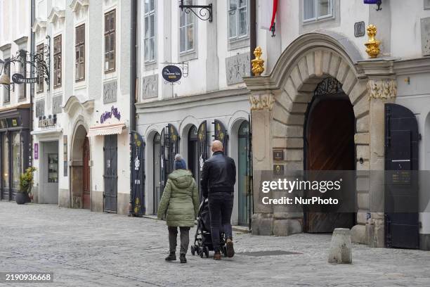 Daily life in Linz, Upper Austria, Austria, on December 26 includes walkers in the old town of Linz.