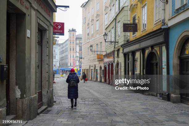 Daily life in Linz, Upper Austria, Austria, on December 26 includes walkers in the old town of Linz.