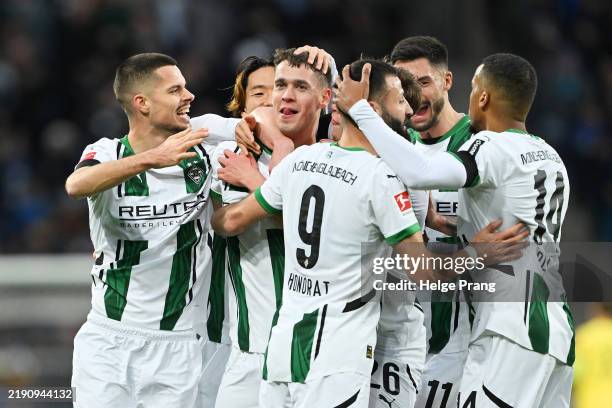 Philipp Sander of Borussia Moenchengladbach celebrates scoring his team's first goal with teammates during the Bundesliga match between TSG 1899...