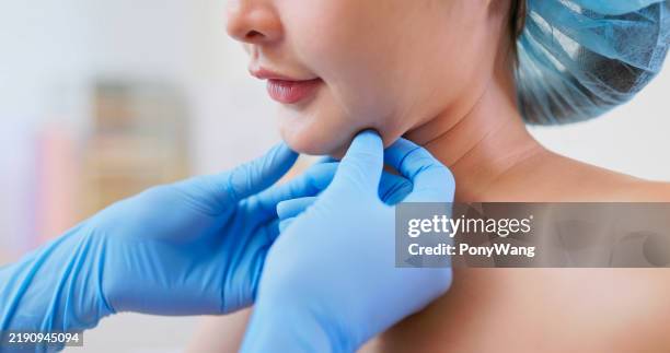 asian woman double chin examined - plastic surgery body stock pictures, royalty-free photos & images