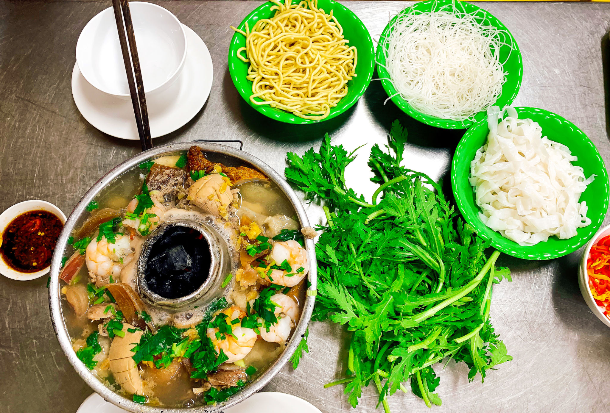 Vietnamese Fish Hot Pot With Reice Noodles, Egg Noodles And Fresh Vegetables. Vietnamese Fish Hot Pot With Reice Noodles, Egg Noodles And Fresh Vegetables.