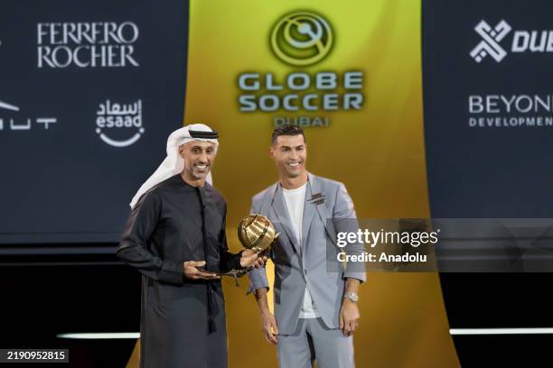 Al-Nassr player Cristiano Ronaldo receives an award during the Globe Soccer Dubai Awards 2024 as a part of the Dubai International Sports Conference...