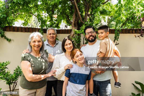 portrait of a family on backyard at home - large family stock pictures, royalty-free photos & images
