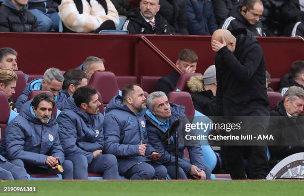 Manchester City goalkeeping coach Xabier Mancisidor, Technical Assistant Inigo Dominguez and assistant coach Juanma Lillo look up at Pep Guardiola...
