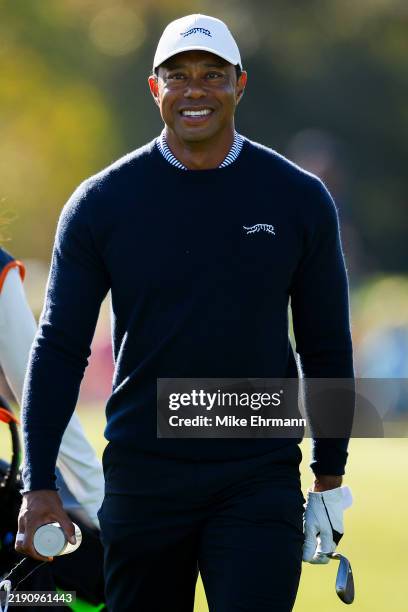 Tiger Woods looks on as he walks to the driving range before the first round of the PNC Championship at Ritz-Carlton Golf Club on December 21, 2024...