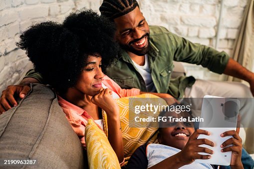 Child boy using digital tablet and talking to parents at home Child boy using digital tablet and talking to parents at home