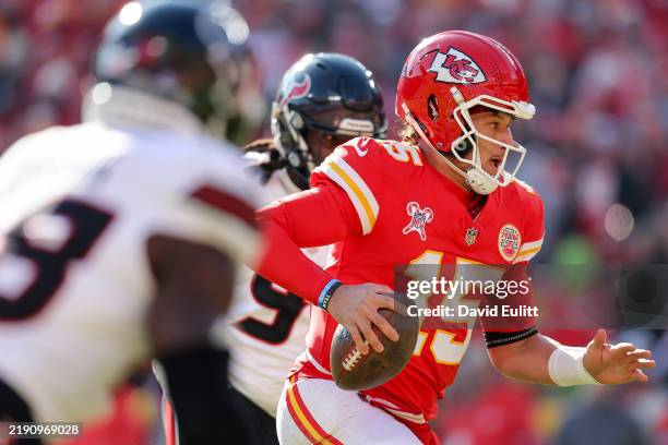 Patrick Mahomes of the Kansas City Chiefs scrambles for a rushing touchdown in the first quarter of a game against the Houston Texans at GEHA Field...