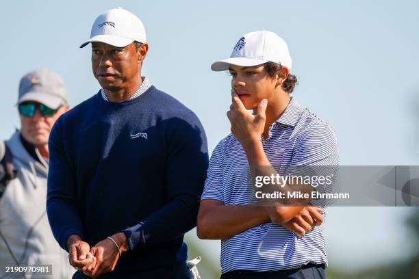 Tiger Woods talks with his son Charlie Woods while they play the second hole during the first round of the PNC Championship at Ritz-Carlton Golf Club...