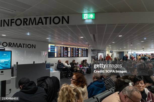Passengers in the Manchester Airport are waiting for their flights in Terminal 3. Fog has caused significant disruption at Manchester Airport,...