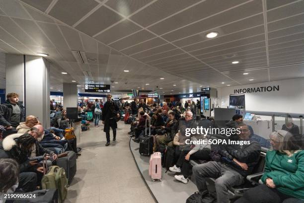Passengers in the Manchester Airport are waiting for their flights in Terminal 3. Fog has caused significant disruption at Manchester Airport,...