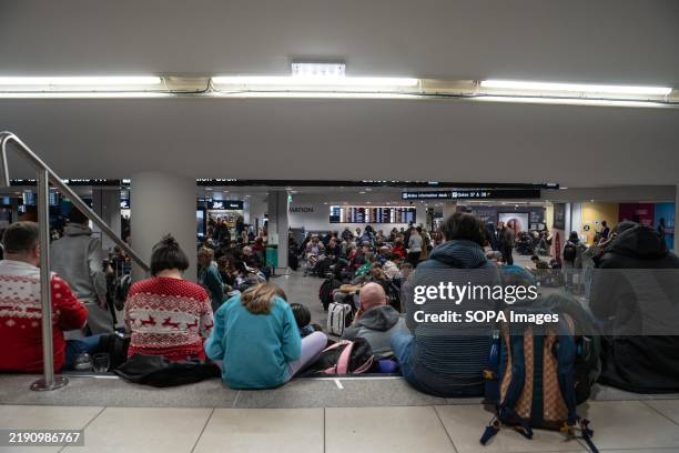 Passengers in the Manchester Airport are waiting for their flights in Terminal 3. Fog has caused significant disruption at Manchester Airport,...