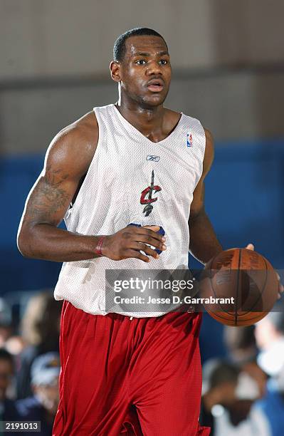 LeBron James of the Cleveland Cavaliers brings the ball upcourt during the Reebok Pro Summer League against the Milwaukee Bucks at Clark Athletic...