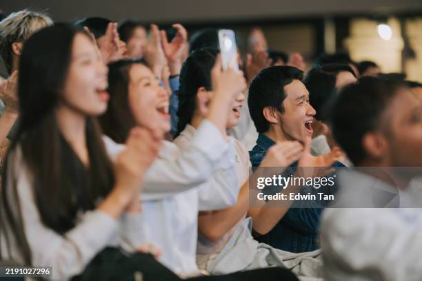 enthusiastic asian mixed aged audience applause cheering at auditorium - enthusiastic theater audience clapping stock pictures, royalty-free photos & images
