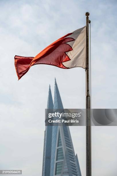 bahrain flag with skyline of manama - bahraini flag stock pictures, royalty-free photos & images