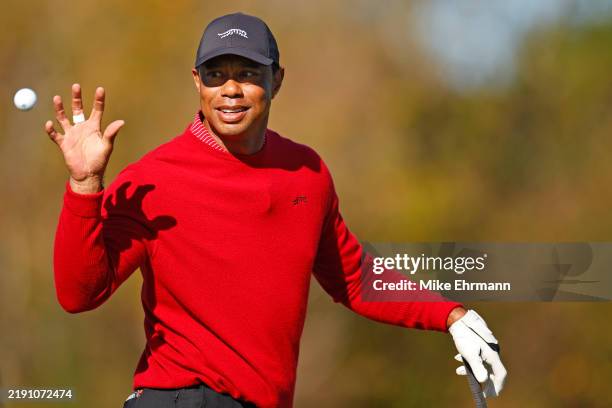 Tiger Woods of the United States warms up on the driving range ahead of the second round of the PNC Championship at Ritz-Carlton Golf Club on...