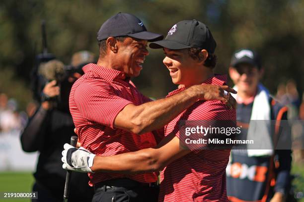 Tiger Woods of the United States reacts with his son Charlie Woods after making the first hole-in-one of his career on the fourth hole during the...