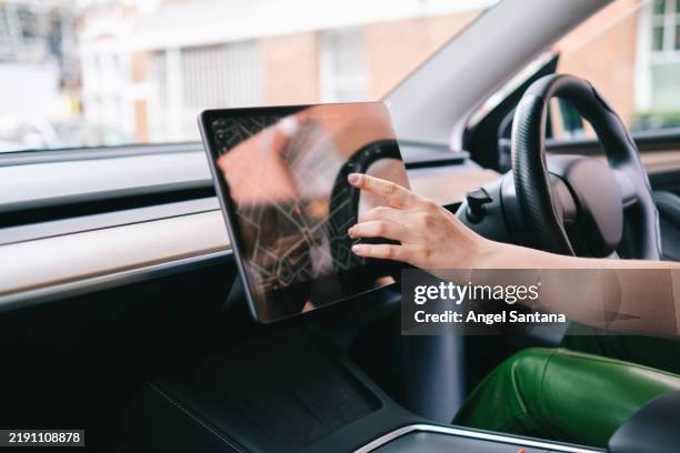 woman using navigation system on car touchscreen while driving - touch screen map stock pictures, royalty-free photos & images