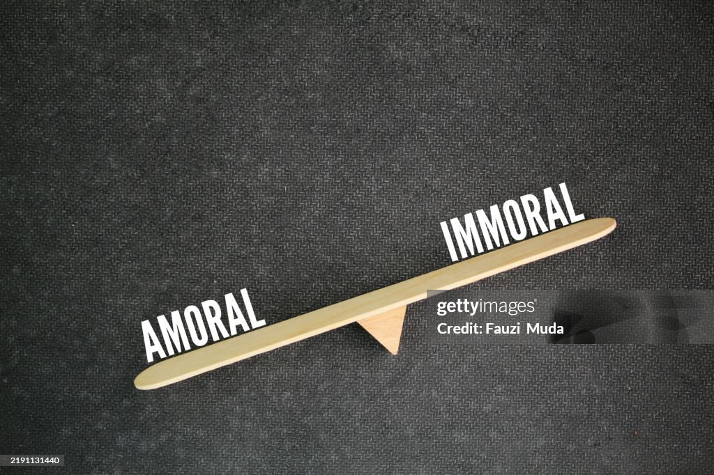 Scales with two words amoral vs immoral. Amoral means lacking morals or being unconcerned with morality. Immoral means going against established morals or behaving unethically.