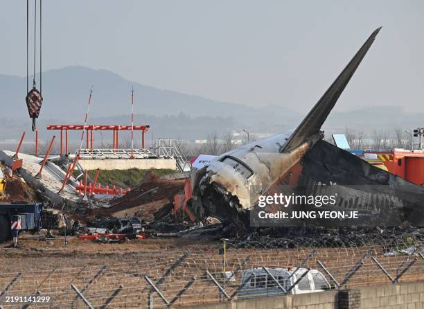 The scene where a Jeju Air Boeing 737-800 series aircraft crashed and burst into flames is seen at Muan International Airport in Muan, some 288...