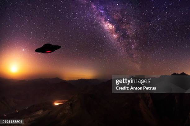 unidentified flying objects over the mountains at night. ufo invasion - invading space stock pictures, royalty-free photos & images