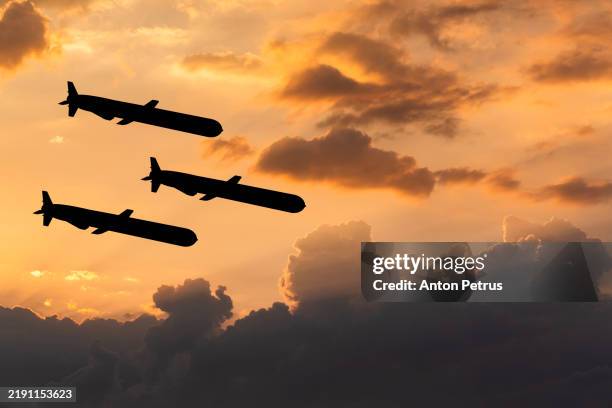 cruise missiles against the sunset sky - tomahawk stock pictures, royalty-free photos & images