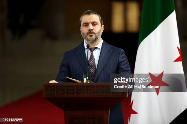 Syria's newly appointed Foreign Minister Asaad Hassan al-Shibani during a press conference after a meeting between the Syrian leadership and a...