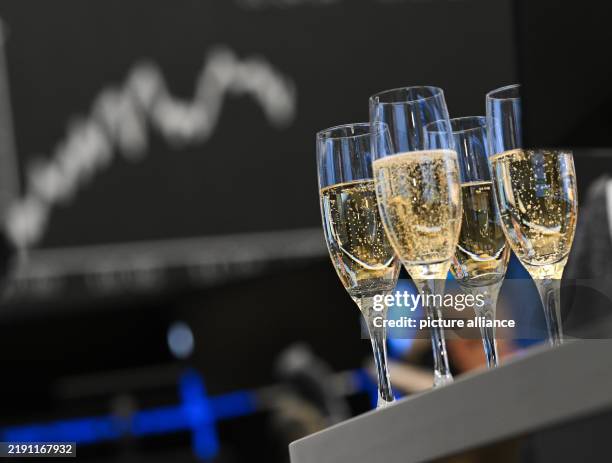 December 2024, Hesse, Frankfurt/Main: On the last trading day of the year, champagne glasses are ready for a toast in the trading hall of the stock...