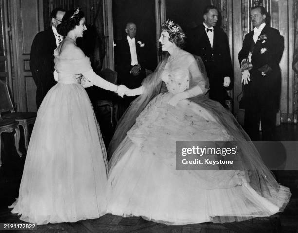 Princess Margaret shaking hands with Lady Diana Cooper at a charity ball in Paris, France, November 22nd 1951. The event in aid of the Paris-based...