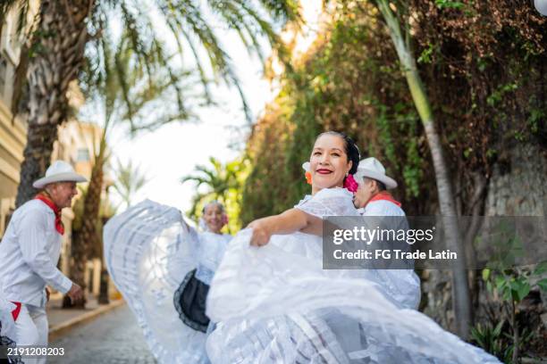 mature traditional mexican dancer woman dancing outdoors - traditional musician stock pictures, royalty-free photos & images