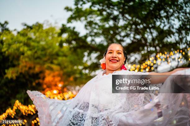 portrait of mature traditional mexican dancer woman dancing outdoors - traditional dress mexico stock pictures, royalty-free photos & images