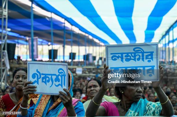 People of Sandeshkhali gathered with posters of varous governmental schemes in an Adminstrative Meeting as Chief Minister Mamata Banerjee addressing...
