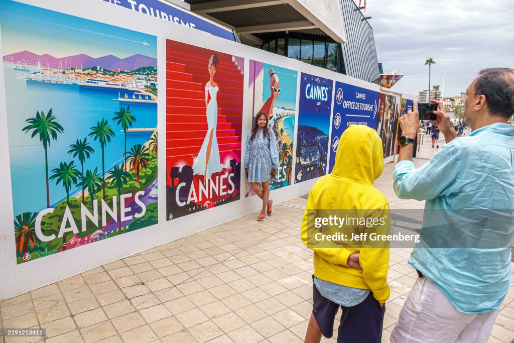 Cannes, France, Le Croisette, Palais des Festivals et des Congres, Cannes Film Festival Palace, Walk of Fame, giant posters, visitors posing with