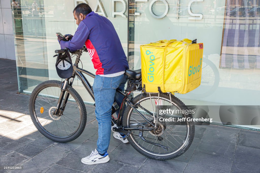 Barcelona, Spain, Catalonia, Carrer de Tarragona Eixample, Glovo bicycle courier delivery food service
