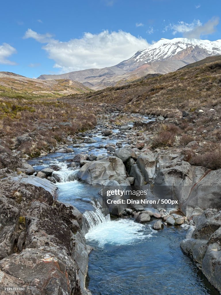 Scenic view of river by mountains against sky,Tongariro National Park,New Zealand