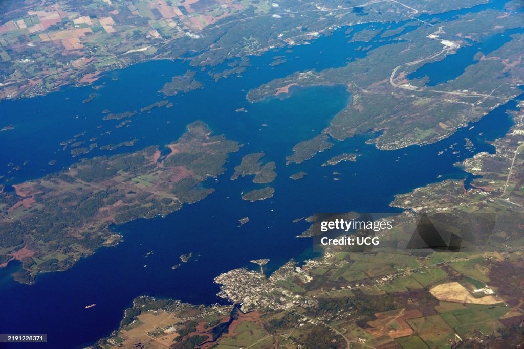 St. Lawrence River, USA-Canada border, looking north. Grindstone and (left) Wellesley (R) Islands are the two largest Islands. Prominent bay near the center of the photo is Eel Bay. Town in lower center is Clayton, New York.
