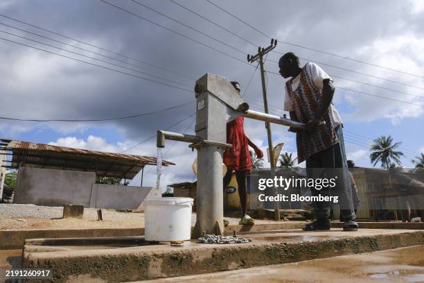 Local residents fetch water from a mechanized borehole near the Bonsa river in Bonsa, Ghana, on Wednesday, Oct. 16, 2024. The indebted West African...
