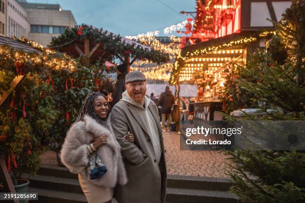 lifestyle shoot of a beautiful mixed race couple at a christmas market in 2024 - julmarknad bildbanksfoton och bilder
