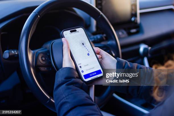 driver using navigation app on smartphone while driving car - location tracking stock pictures, royalty-free photos & images