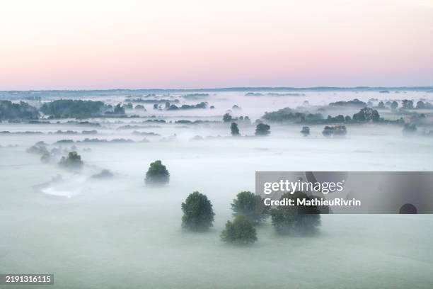 aerial view of the loire and allier valleys in the mist at sunrise - auvergne stock pictures, royalty-free photos & images