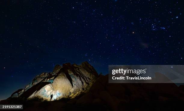 exploring the rocks under a starry night - meteor space stock pictures, royalty-free photos & images