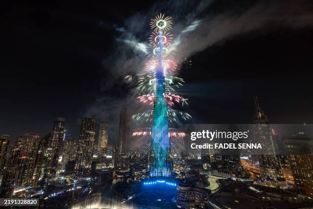 This photograph shows fireworks exploding around the Burj Khalifa Tower during New Year's celebrations in Dubai on January 1, 2025.