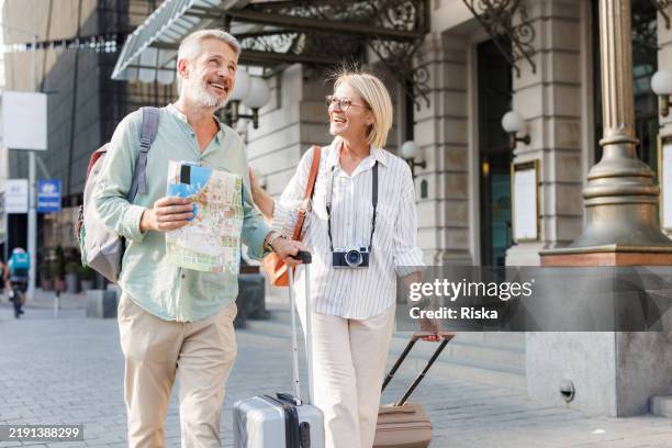 mature tourist on a city walk - mature couple traveling stock pictures, royalty-free photos & images