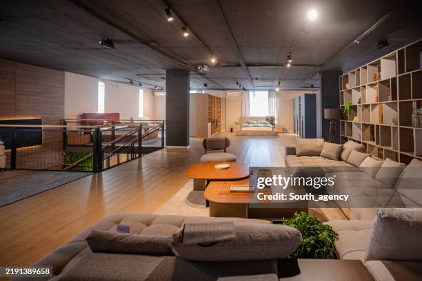 modern lounge with spacious seating arrangement showcased - furniture store stock pictures, royalty-free photos & images