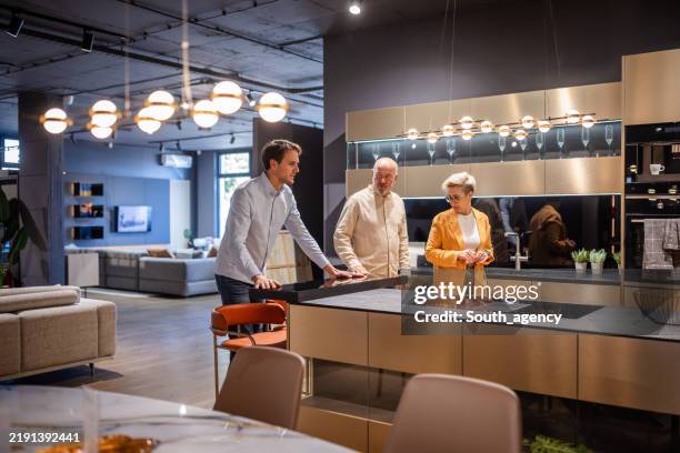 kitchen showroom exploration with modern island features - utställningsrum bildbanksfoton och bilder