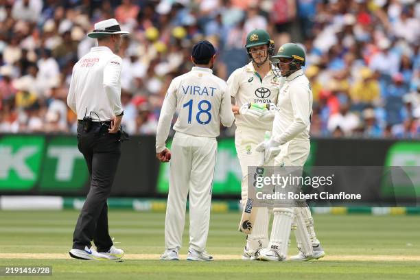 Umpire Michael Gough speaks with Virat Kohli of India and Sam Konstas of Australia during day one of the Men's Fourth Test Match in the series...