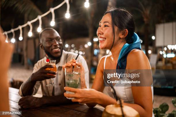 diverse friends bonding at outdoor dinner event - nightlife stock pictures, royalty-free photos & images
