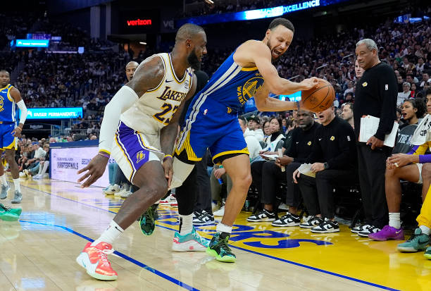 Stephen Curry of the Golden State Warriors is fouled by LeBron James of the Los Angeles Lakers during the second half at Chase Center on December 25,...